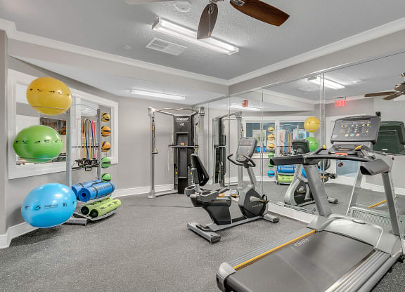 fitness center with equipment and mirror