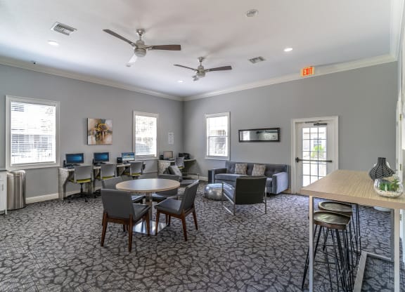 a room with couches and chairs and a table and chairs