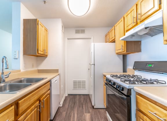 a kitchen with wood cabinets and white appliances