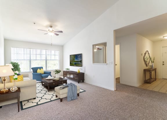 a living room with white walls and carpet
