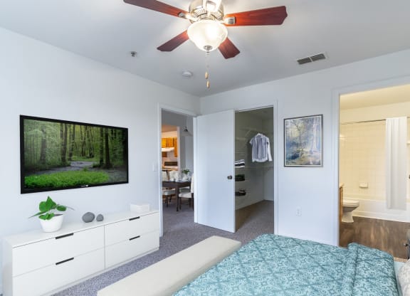 a bedroom with a bed and a ceiling fan