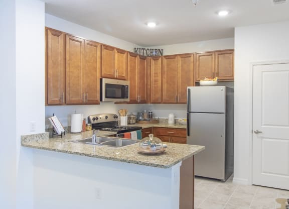 a kitchen with a granite counter top and stainless steel appliances