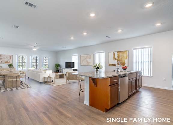 A spacious single family home with a kitchen, dining area, and living room.
