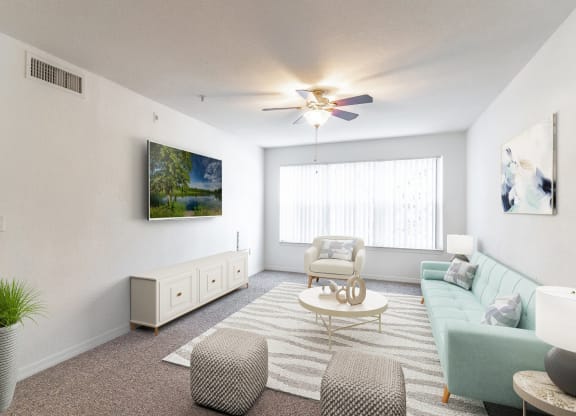 a living room with white walls and a large window