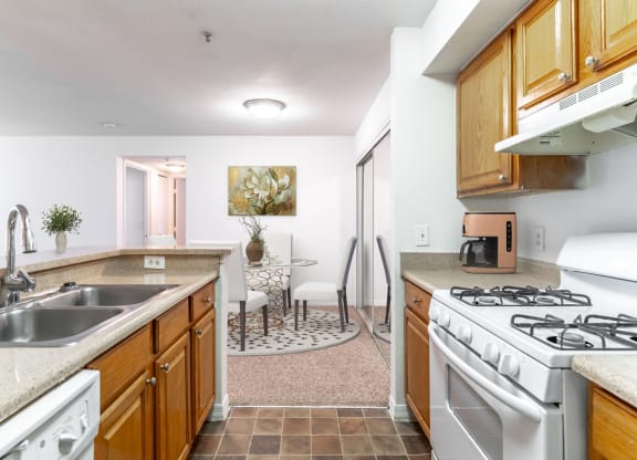a kitchen with white appliances and wooden cabinets