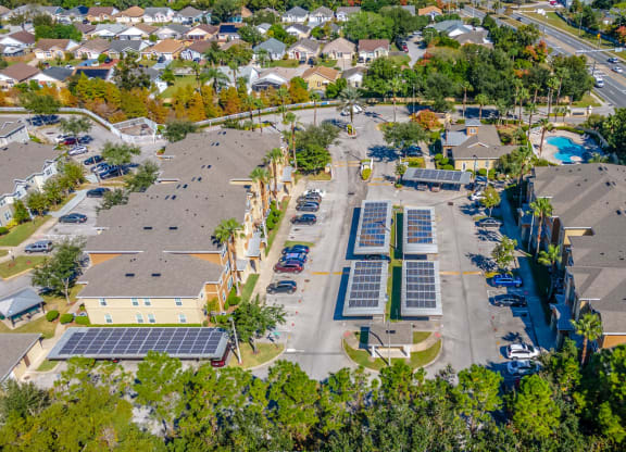 an aerial view of a neighborhood with solar panels on the roofs