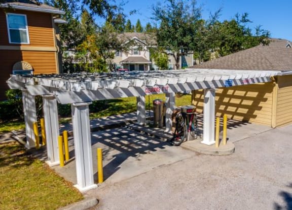 a bike parked under awning in front of a house