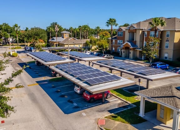 a row of solar panels sits in the middle of a parking lot