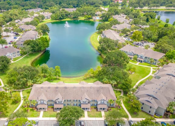 an aerial view of a neighborhood with a lake and houses