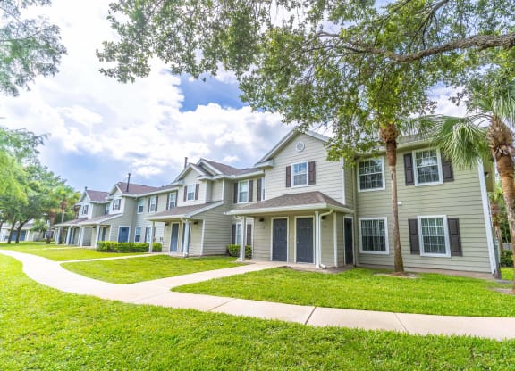 a row of townhomes with trees in front of them