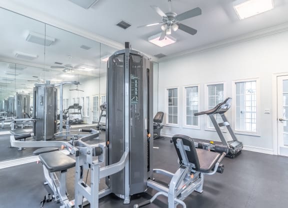 fitness center with equipment and mirror