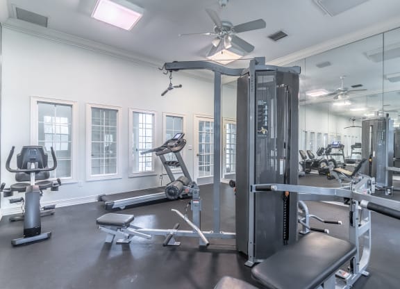 fitness center with equipment and mirror