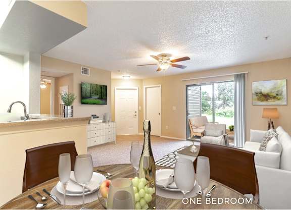 A well-lit one bedroom apartment with a dining table set for two.