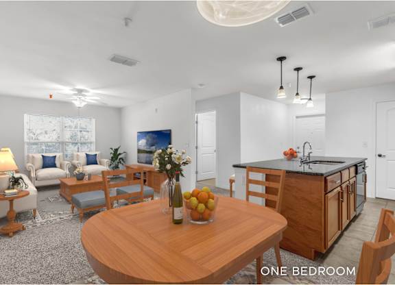 A modern kitchen and living room with a wooden table and chairs.