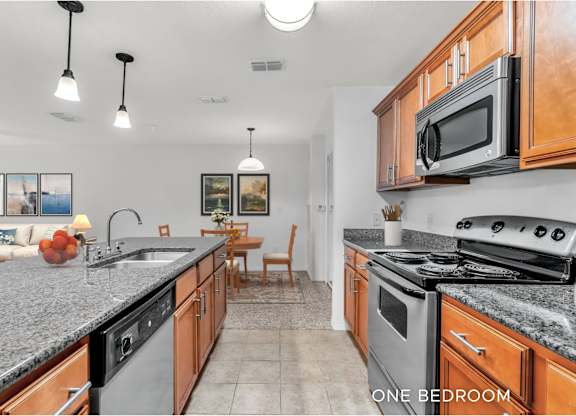 A kitchen with granite countertops and a stainless steel dishwasher.