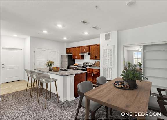 A kitchen with a table and chairs in the middle of the room.