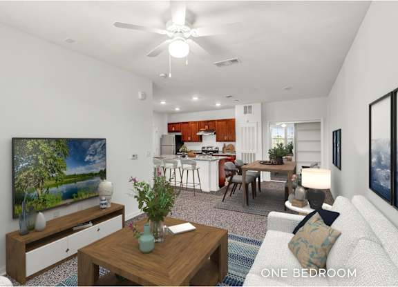 A modern living room with a television, a dining area, and a kitchen in the background.