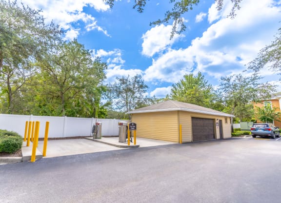 a yellow garage with a car parked in front of it