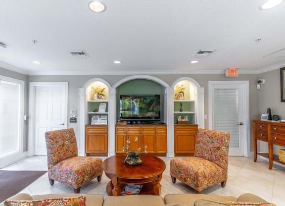 a living room with couches and a table and a television
