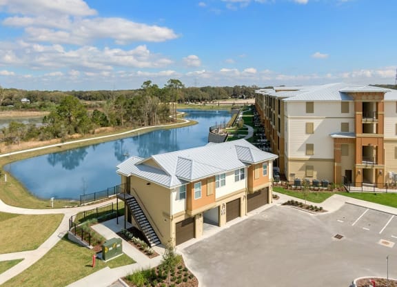 an aerial view of carriage homes with lake behind