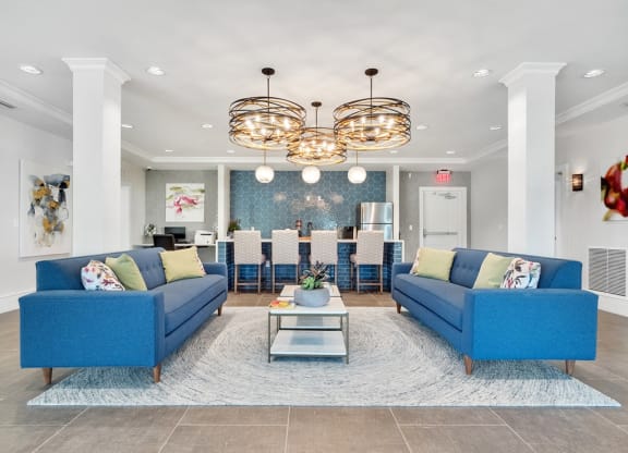 a view of the clubhouse seating area with couches and a kitchen