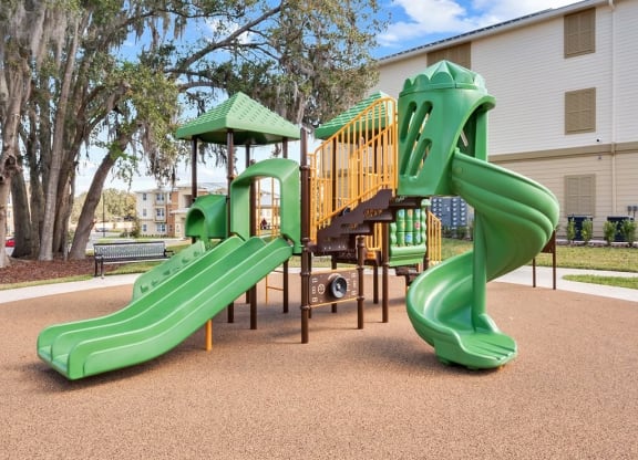 a playground area with playset and slide