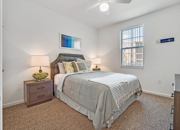 a bedroom with a bed and a ceiling fan