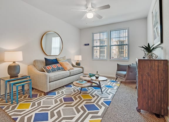 a living room with a couch and a rug