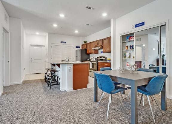 a kitchen and dining area with a table and chairs