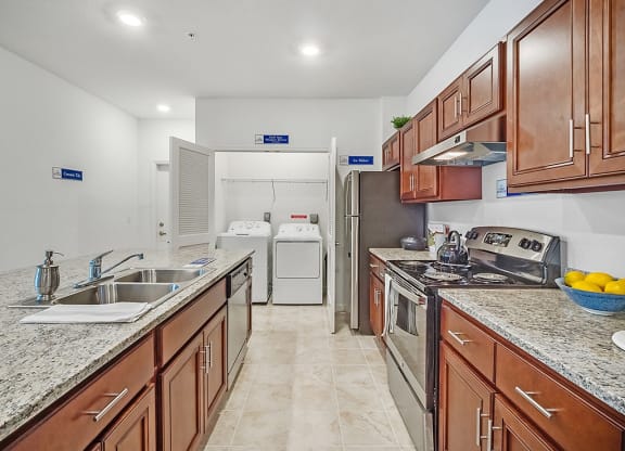 a kitchen with wooden cabinets and granite counter tops