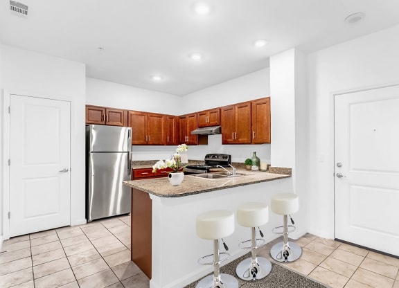 a kitchen with a breakfast bar and stainless steel appliances
