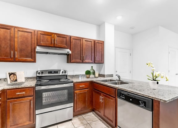 a kitchen with wood cabinets and stainless steel appliances