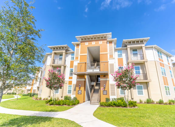 an apartment building with a sidewalk in front of it