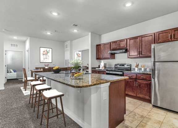 kitchen with barstools and dark cabinetry