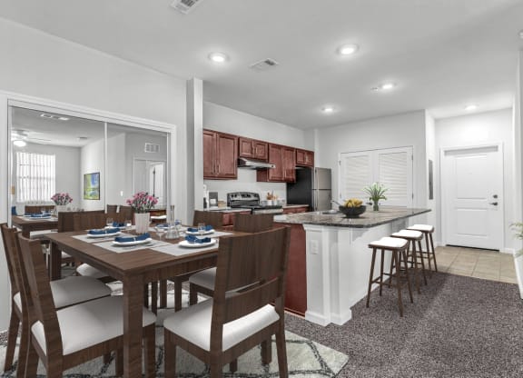 dining area with table and chairs and a kitchen with barstools and dark cabinets