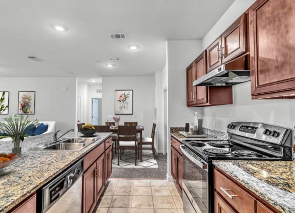 a kitchen with wooden cabinets and granite countertops