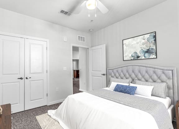 a bedroom with a bed and a ceiling fan