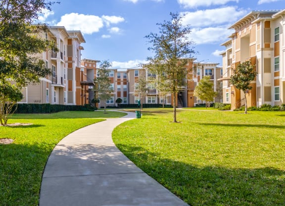 an exterior view of an apartment building on a sunny day