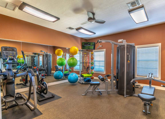 fitness center with equipment and mirror