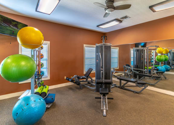 fitness center with equipment and mirror