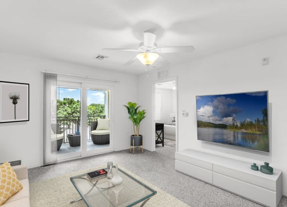 a living room with white walls and a white ceiling fan