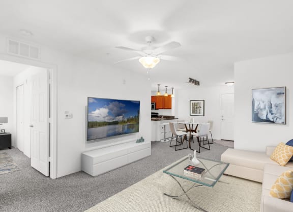a living room with white walls and carpet