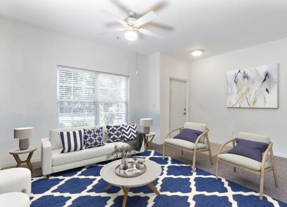a living room with a couch and two chairs