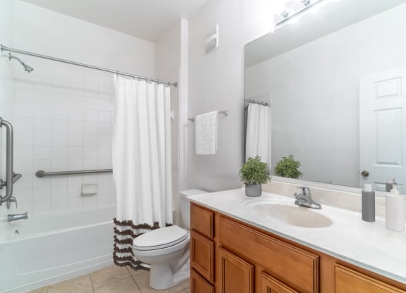 a bathroom with a white toilet next to a bathtub with a shower curtain