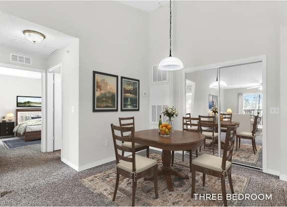 A dining room with a table set for four.