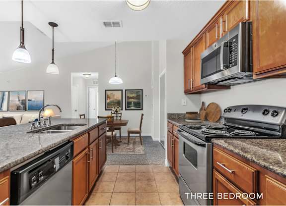 A kitchen with a stove top oven and microwave.