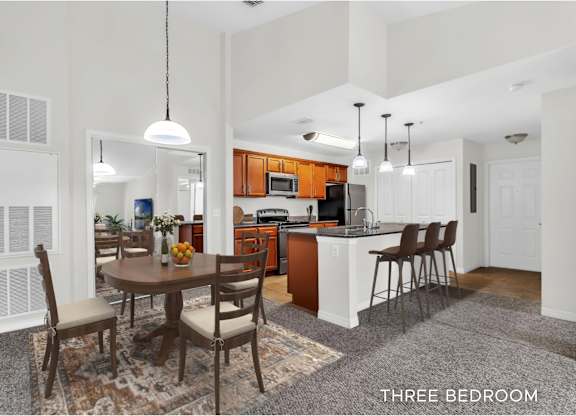 A kitchen with a table and chairs in the middle of the room.