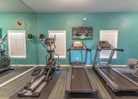 fitness center with equipment and mirror