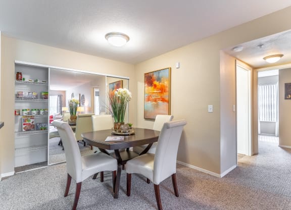 a dining area with a table and chairs