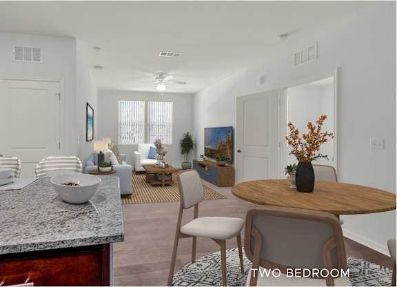 A modern kitchen with a dining table and chairs.